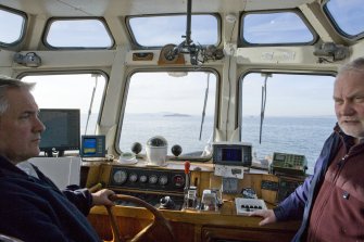 En route to the island, boat owner Bill Simpson and RCAHMS field surveyor David Easton.