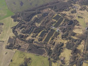 Oblique aerial view centred on part of the remains of the Ordnance Factory, taken from the NNE.