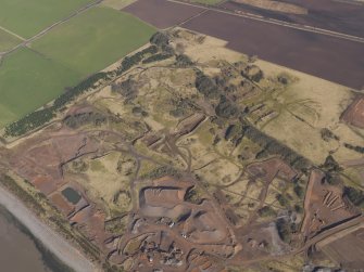 Oblique aerial view centred on part of the remains of the Ordnance Factory, taken from the SE.
