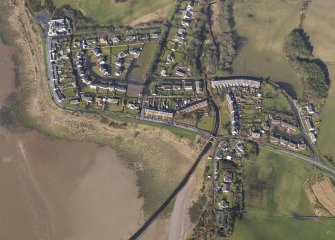 Oblique aerial view centred the village, taken from the E.