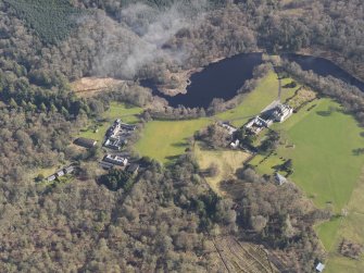 General oblique aerial view centred on the country house with the stables adjacent, taken from the WSW.