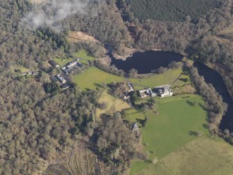 General oblique aerial view centred on the country house with the stables adjacent, taken from the SSW.