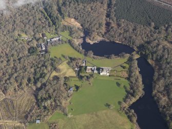 General oblique aerial view centred on the country house with the stables adjacent, taken from the SSE.