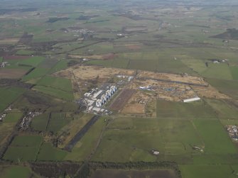 General oblique aerial view centred on the Nuclear power station with the airfield adjacent, taken from the E.