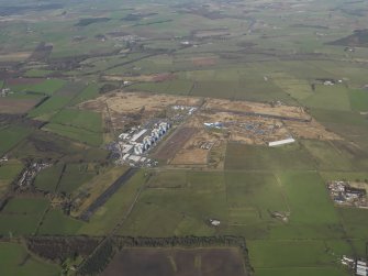 General oblique aerial view centred on the Nuclear power station with the airfield adjacent, taken from the E.