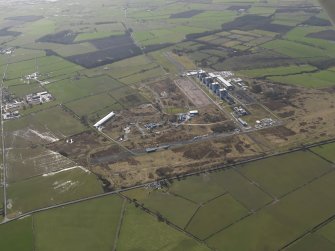 General oblique aerial view centred on the Nuclear power station with the airfield adjacent, taken from the NW.