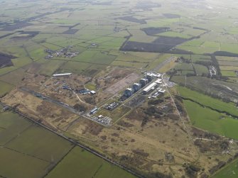 General oblique aerial view centred on the Nuclear power station with the airfield adjacent, taken from the W.
