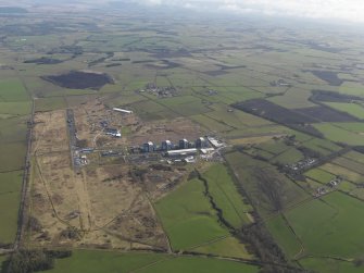 General oblique aerial view centred on the Nuclear power station with the airfield adjacent, taken from the SW.