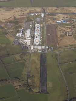 Oblique aerial view centred on the Nuclear power station with the airfield adjacent, taken from the SE.