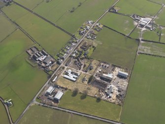 Oblique aerial view centred on the village with the airfield domestic site adjacent, taken from the WNW.