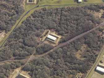 Oblique aerial view centred on a single bunker in the explosives works, taken from the SW.