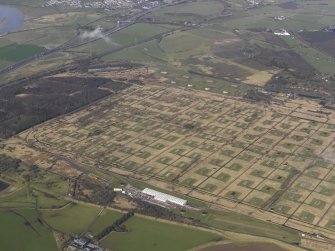 Oblique aerial view centred on the explosives stores, taken from the SE.