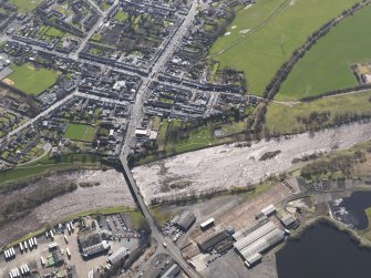 General oblique aerial view centred on the town with the site of the railway bridge adjacent , taken from the NNW.