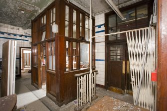 Interior. View of the main entrance door, the ticket office and the turnstile at the entrance to the bath house.