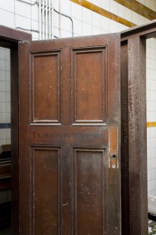 Interior. View of turkish bath entrance door, with stencilled lettering.