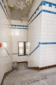 Interior. View looking down the main stair of the bath house, from first floor level.