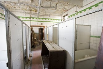 Interior. View looking along the rows of cubicles within the female bath salon.