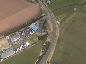 Oblique aerial view centred on the remains of the railway station, taken from the SW.