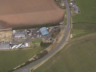 Oblique aerial view centred on the remains of the railway station, taken from the SSW.