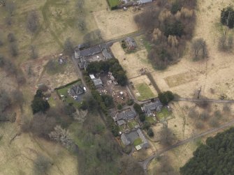 Oblique aerial view centred on the stables with the laundry adjacent, taken from the NE.