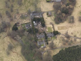 Oblique aerial view centred on the stables with the laundry adjacent, taken from the NE.