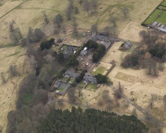 Oblique aerial view centred on the stables with the laundry adjacent, taken from the NNE.