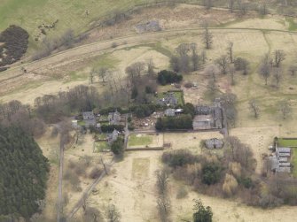 Oblique aerial view centred on the stables with the laundry adjacent, taken from the NW.