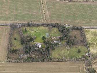 Oblique aerial view centred on the country house with the  walled garden, gate-lodges and cottage adjacent, taken from the NNW.