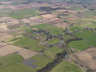 General oblique aerial view centred on the village, taken from the SE.