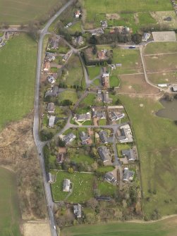 Oblique aerial view centred on the village, taken from the W.