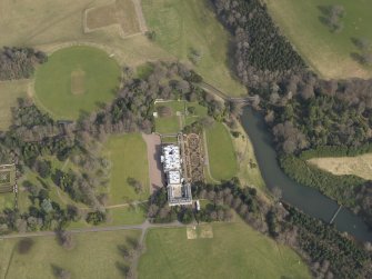 Oblique aerial view centred on the country house with the formal garden adjacent, taken from the WSW.