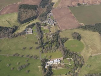 Oblique aerial view centred on the country house with the formal garden adjacent, taken from the S.
