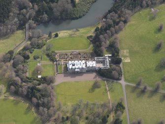 Oblique aerial view centred on the country house with the formal garden adjacent, taken from the NNW.