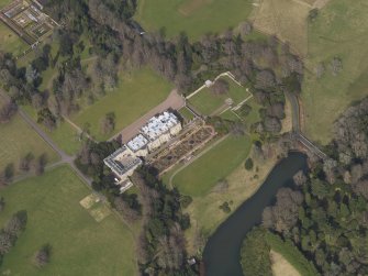 Oblique aerial view centred on the country house with the formal garden adjacent, taken from the SSW.