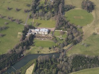 Oblique aerial view centred on the country house with the formal garden adjacent, taken from the SSE.