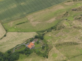 Oblique aerial view of the practice trench system showing as parchmarks in the grass of Kinghorn Golf Course, Fife, taken from the S.