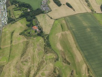Oblique aerial view of the practice trench system showing as parchmarks in the grass of Kinghorn Golf Course, taken from the E.