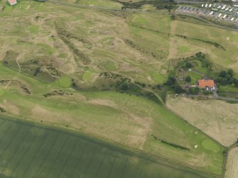 Oblique aerial view of the practice trench system showing as parchmarks in the grass of Kinghorn Golf Course, taken from the NNW.