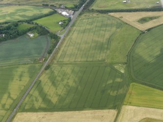 Oblique aerial view of the cropmarks of the unenclosed settlement and pits, taken from the SW.