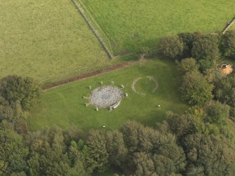 Oblique aerial view of the remains of the recumbent stone circle and enclosed cremation cemetery at Loanhead of Daviot, taken from the SW.