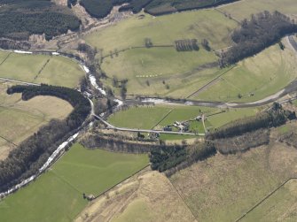 Oblique aerial view centred on the remains of the railway and the area of the demolished railway viaduct, taken from the NW.