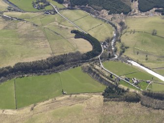 Oblique aerial view centred on the remains of the railway and the area of the demolished railway viaduct, taken from the WNW.