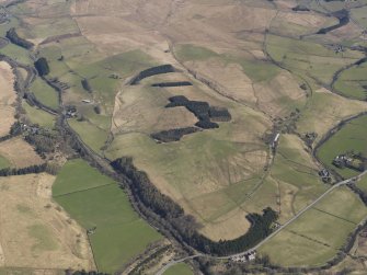 Oblique aerial view centred on the remains of the railway and the area of the demolished railway viaduct, taken from the SSW.