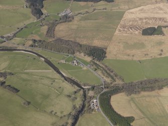 Oblique aerial view centred on the remains of the railway and the area of the demolished railway viaduct, taken from the E.