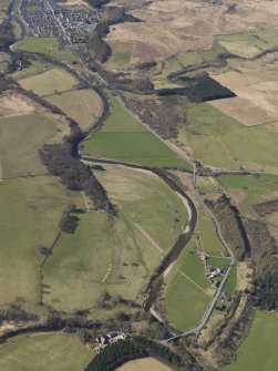 General oblique aerial view centred on the remains of the railway and the area of the demolished railway viaduct, taken from the NE.