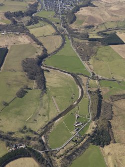 General oblique aerial view centred on the remains of the railway and the area of the demolished railway viaduct, taken from the NNE.