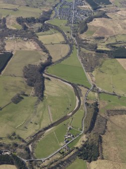 General oblique aerial view centred on the remains of the railway and the area of the demolished railway viaduct, taken from the NNE.