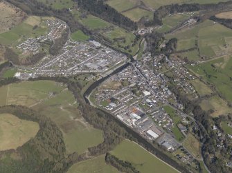 General oblique view centred on the town with the planned village adjacent, taken from the SSE.