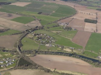 General oblique aerial view centred on the village with the railway viaduct adjacent, taken from the E.