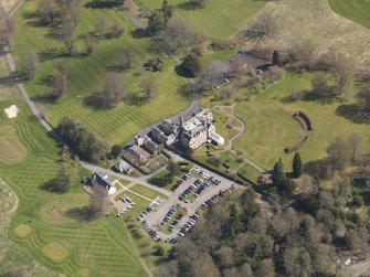 Oblique aerial view centred on the hotel with the stable block adjacent, taken from the WSW.